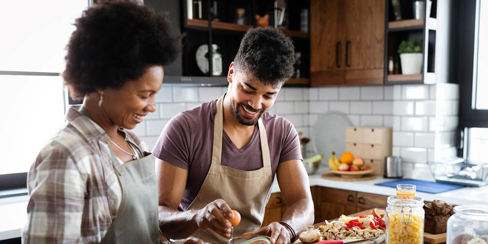 Two people cook at home.