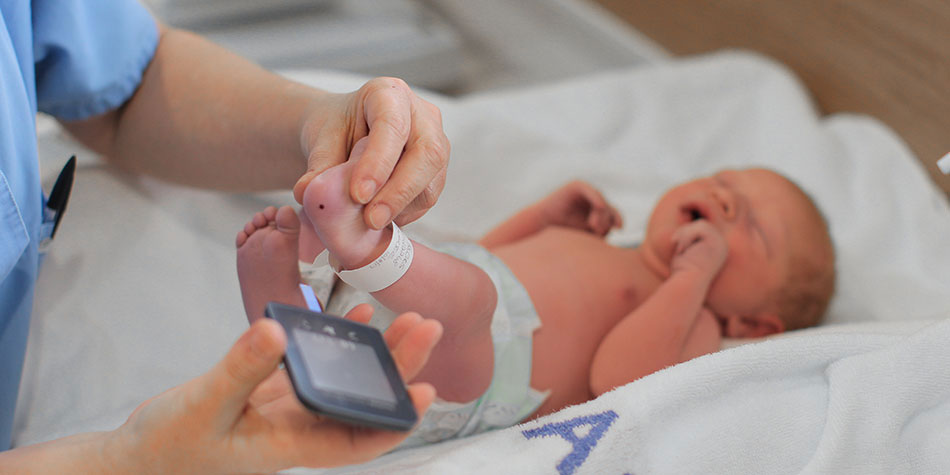 Newborn baby being checked out by a healthcare provider